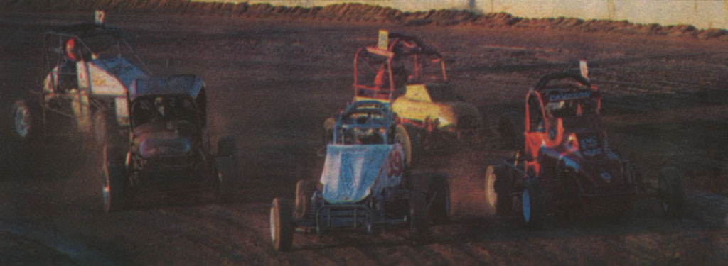 MUD FLIES, CARS SLIDE AT SPEEDWAY OPENING: Mud flies and cars slide as competitorsround a bend during a Limited Sportsman race at Blue Ribbon Speedway, north of Horsham. Mail-Times photographer David Fletcher caught the Limited Sportsmen drivers testing their skills just before sunset during speedway action at the weekend. The race was one of the first at the meet ing which featured an official opening of the Horsham Motor Sports Club track.