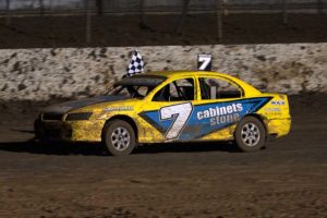 VICTORY LAP: Richard Bansemer carries the chequered flag for a lap around the track PHOTO: Emma Bansemer