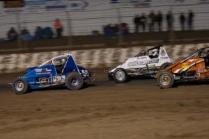 WINGLESS SPRINT CARS: Ashley Armistead leads Jack Oliver into the turn. PHOTO: Emma Bansemer