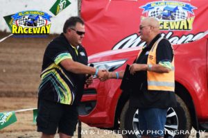 PROUD MOMENT: SSA CEO Greg Lynd presents HMSC President Mick Fitzgerald a plaque to commemorate the club hosting the title race meeting. PHOTO: M&L Speedway Photography